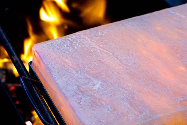 Himalayan Salt tile with handles on the fire.