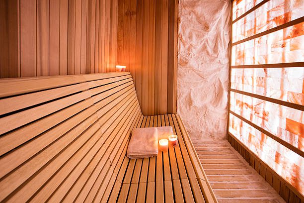 Salt room made of wood with walls made of salt. Halotherapy is a form of alternative medicine. Photo taken under the available light from glowing wall.
